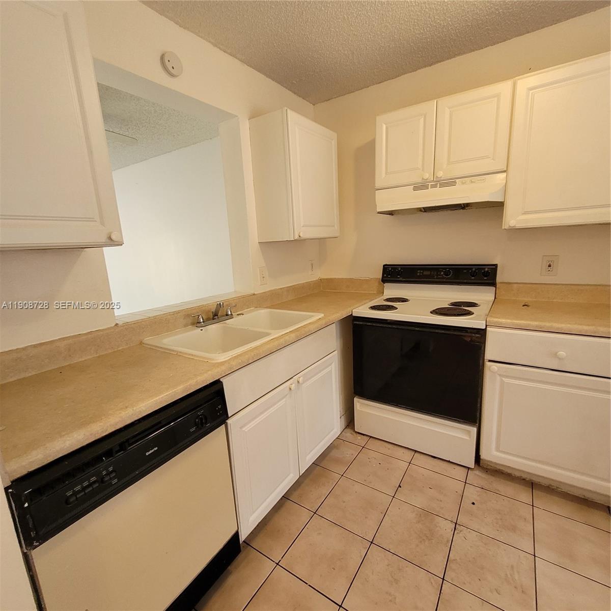 8540 Sherman Circle North, Unit 101 Miramar, FL 33025 - Photo 7 of 36 a kitchen with a sink cabinets and appliances