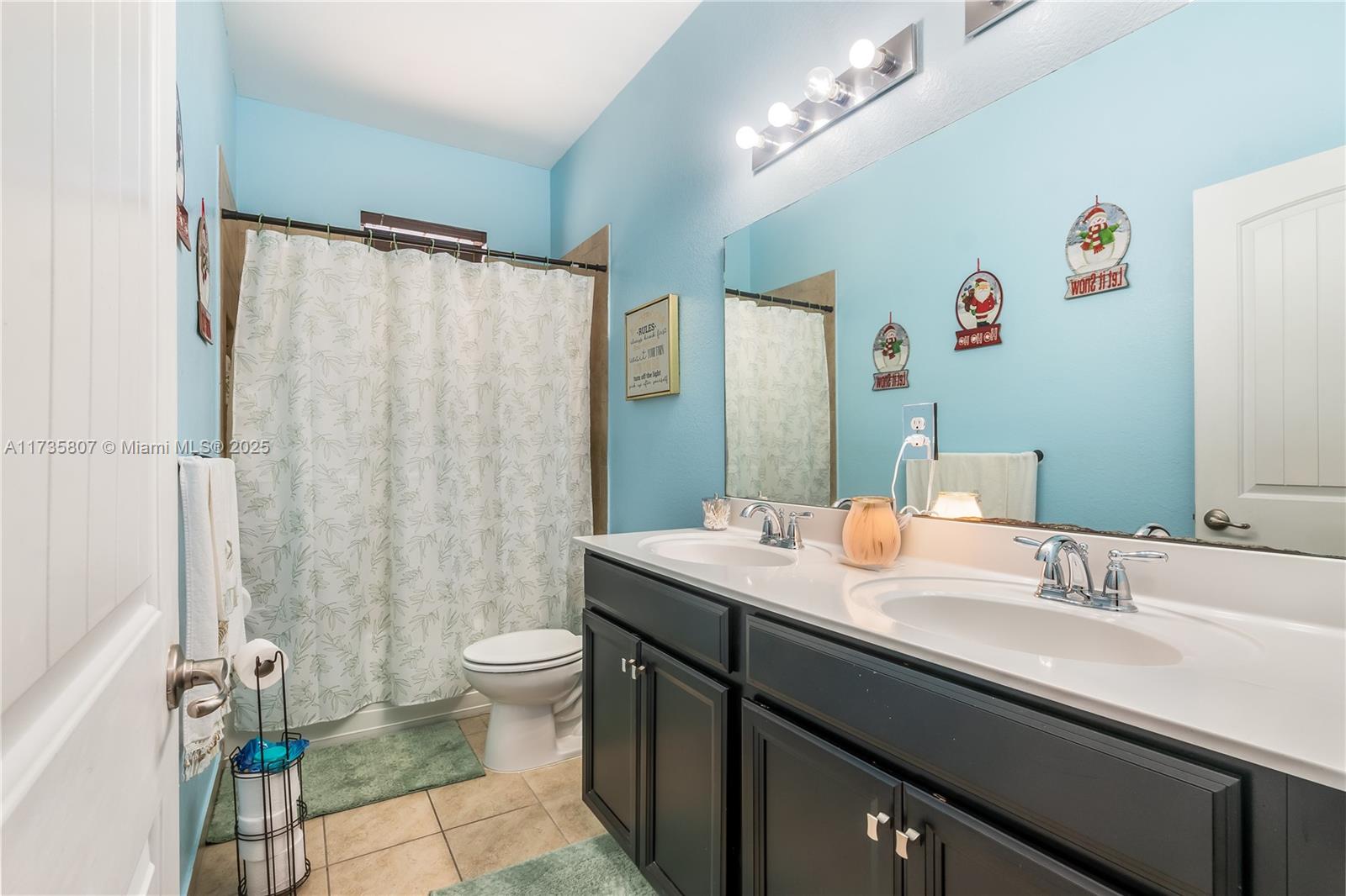 4170 Northeast 20th Street Homestead, FL 33033 - Photo 21 of 52 a bathroom with a sink a toilet and a large mirror