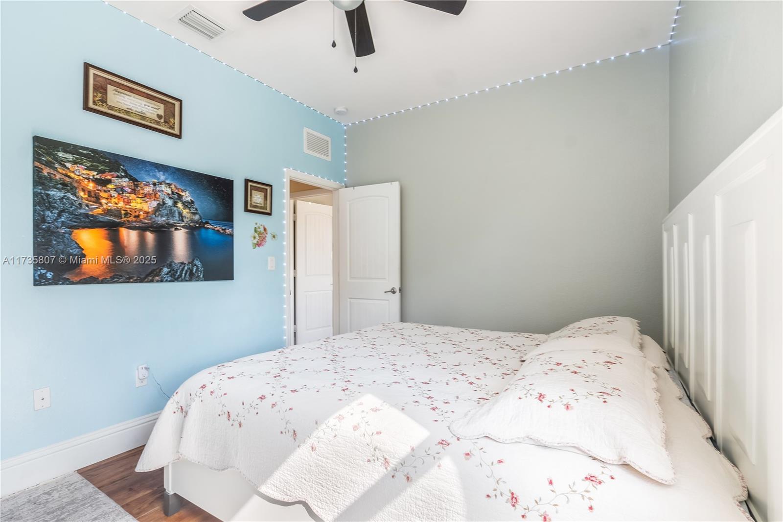 4170 Northeast 20th Street Homestead, FL 33033 - Photo 26 of 52 a bedroom with a bed and a painting on the wall