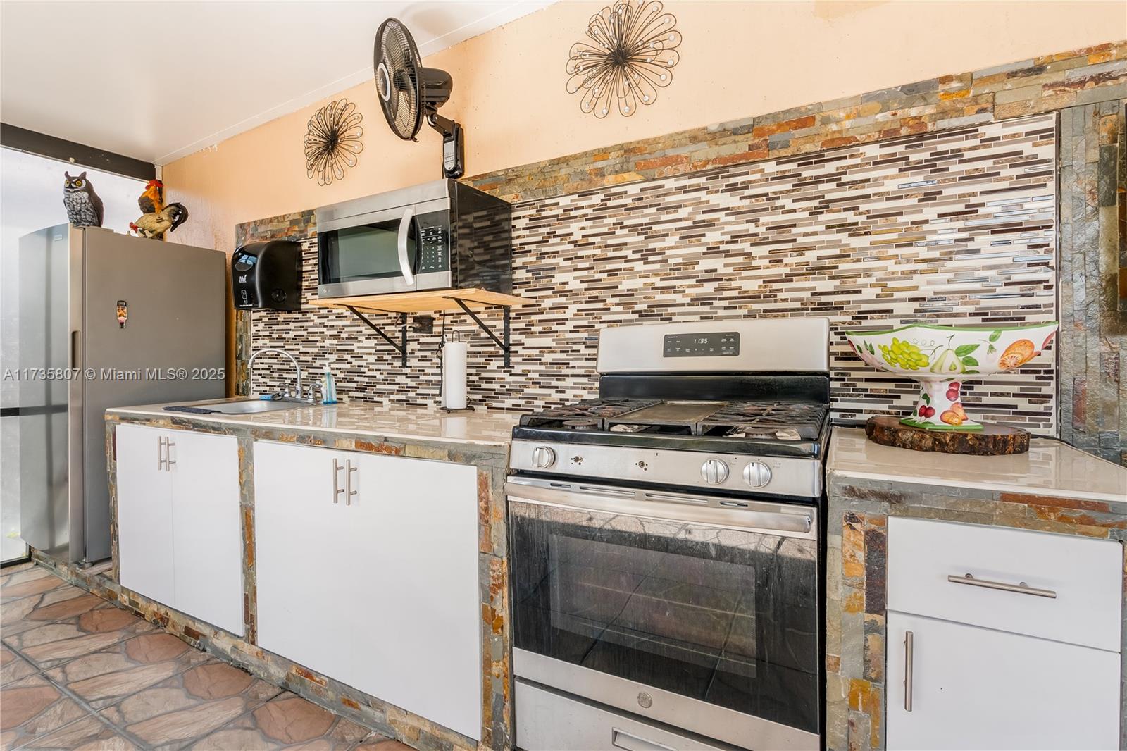 4170 Northeast 20th Street Homestead, FL 33033 - Photo 41 of 52 a kitchen with stainless steel appliances granite countertop a stove and a sink