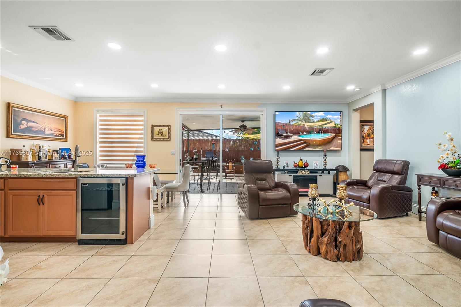 4170 Northeast 20th Street Homestead, FL 33033 - Photo 7 of 52 a living room with furniture a flat screen tv and kitchen view
