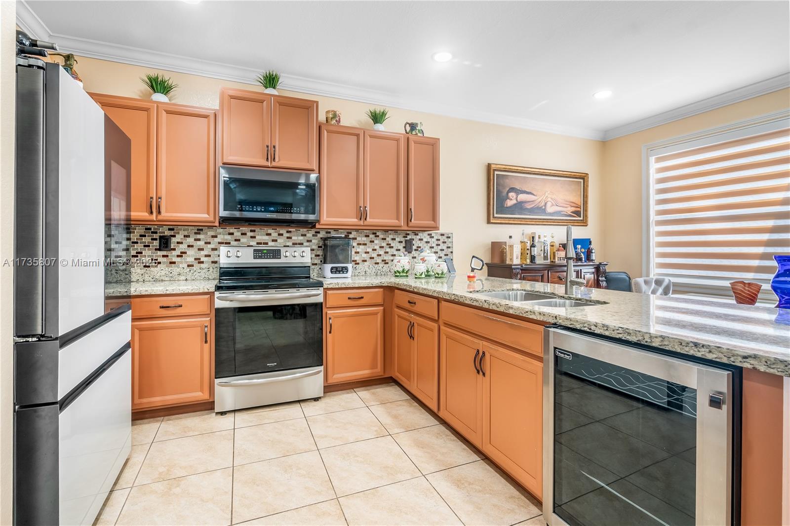 4170 Northeast 20th Street Homestead, FL 33033 - Photo 8 of 52 a kitchen with stainless steel appliances granite countertop a sink and cabinets