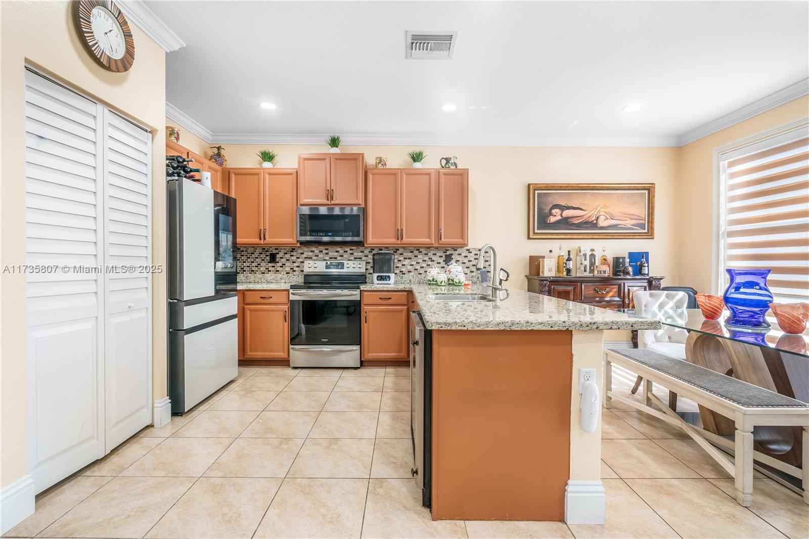 4170 Northeast 20th Street Homestead, FL 33033 - Photo 9 of 52 a kitchen with stainless steel appliances a stove top oven a sink a counter top space and cabinets