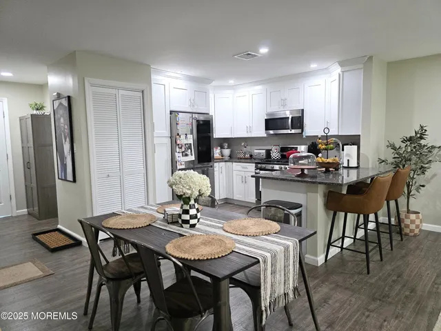 a dining room with furniture and wooden floor