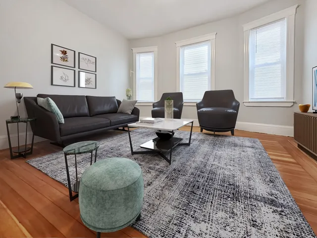 a living room with furniture and a rug