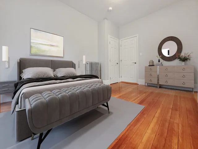 a bedroom with a bed and a dresser