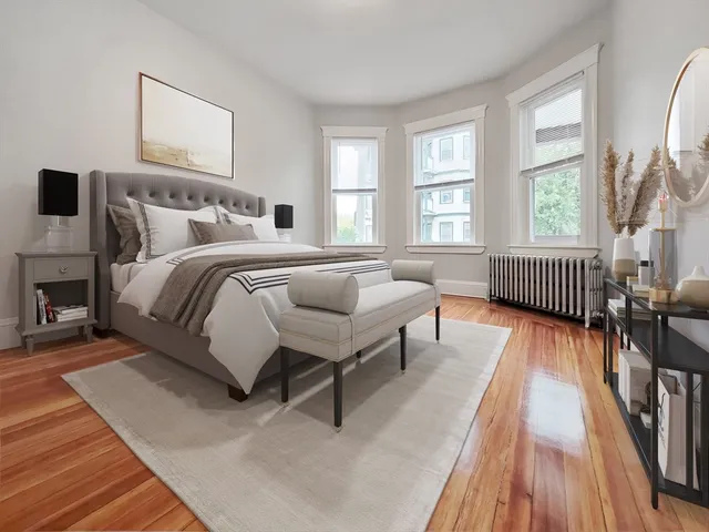 a bedroom with furniture and a wooden floor