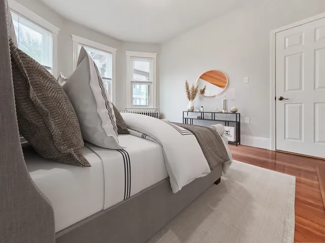 a bedroom with a bed and window