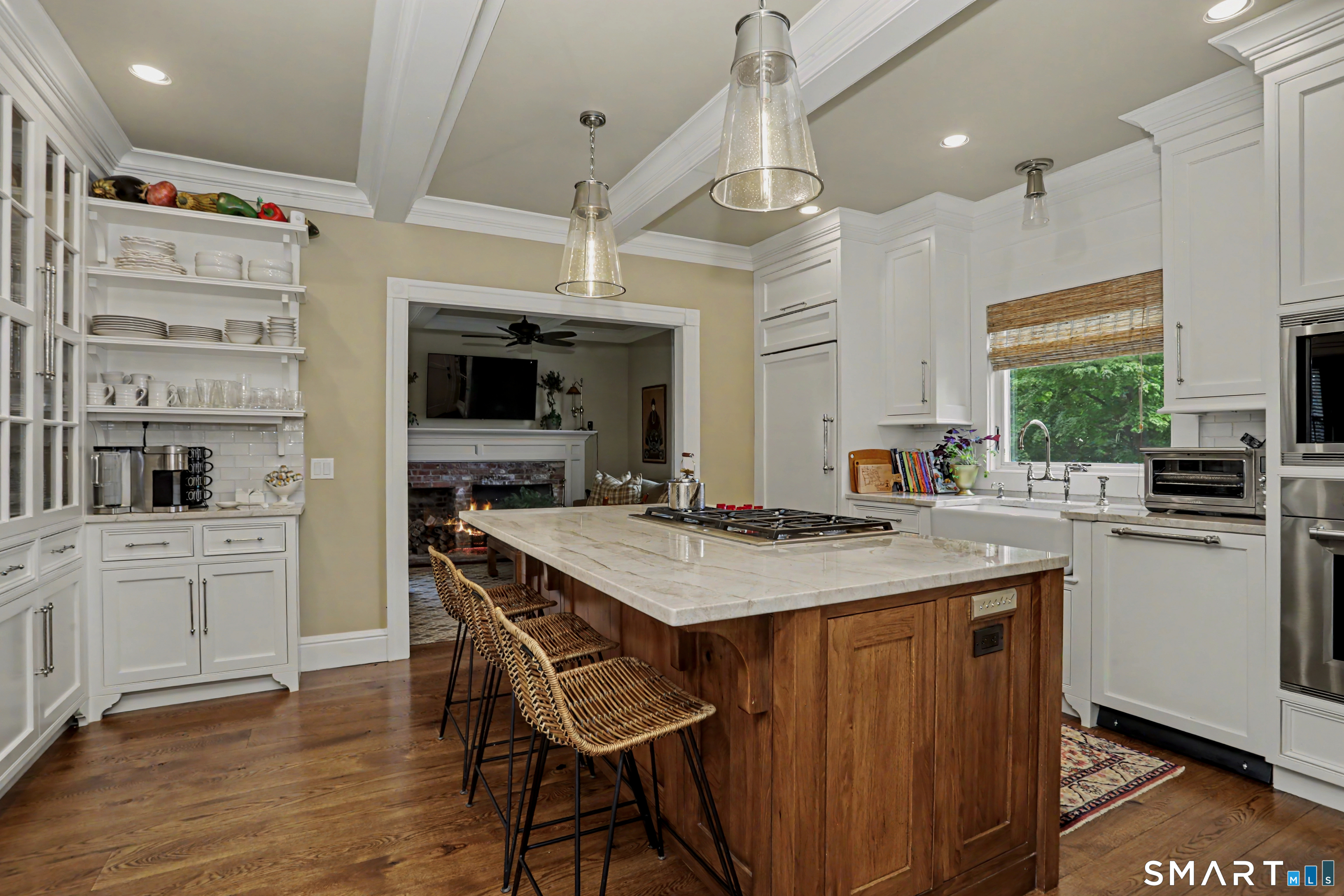 36 Catoonah Street, Unit 18 Ridgefield, CT 06877 - Photo 12 of 40 a kitchen with stainless steel appliances kitchen island granite countertop a table chairs sink and cabinets