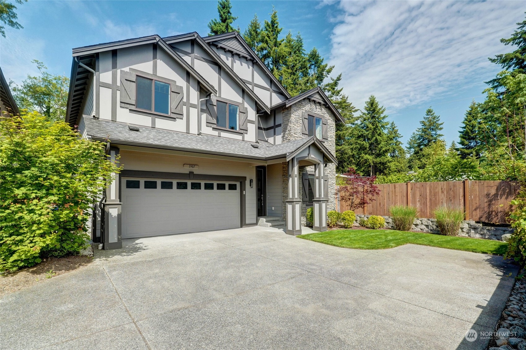 1907 240th Place Southwest Bothell, WA 98021 - Photo 1 of 28 a front view of a house with garden and garage
