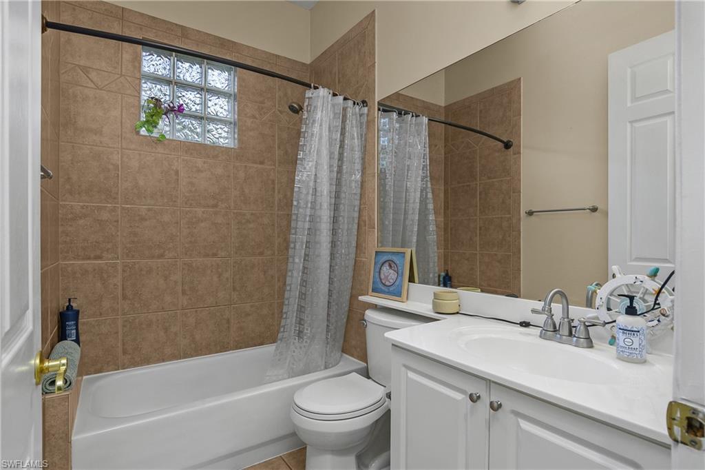 6175 Green Boulevard Naples, FL 34116 - Photo 11 of 20 a bathroom with a sink a toilet and a bathtub