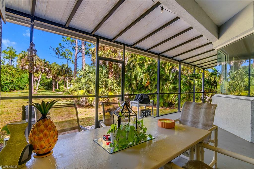 6175 Green Boulevard Naples, FL 34116 - Photo 14 of 20 a view of a patio with a table chairs and a potted plant