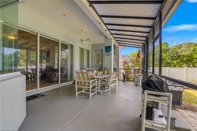 a dining room with furniture and a floor to ceiling window