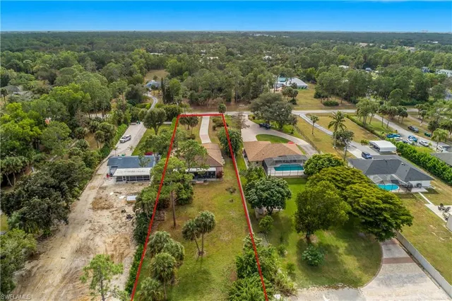 an aerial view of residential house with outdoor space and trees