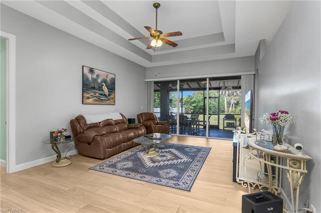 6175 Green Boulevard Naples, FL 34116 - Photo 4 of 20 a living room with furniture and a wooden floor