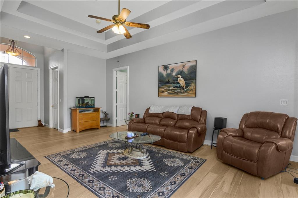 6175 Green Boulevard Naples, FL 34116 - Photo 5 of 20 a living room with furniture rug and a table