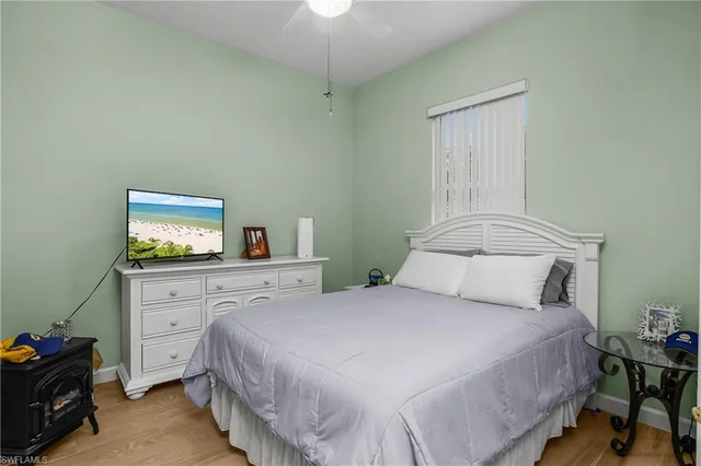 a bedroom with a bed and a tv on the dresser
