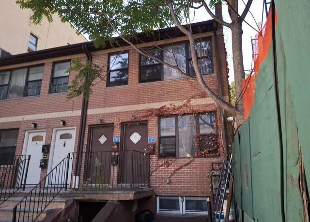 a view of a house with a tree