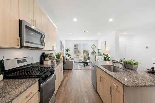 a large kitchen with lots of counter top space a sink and appliances
