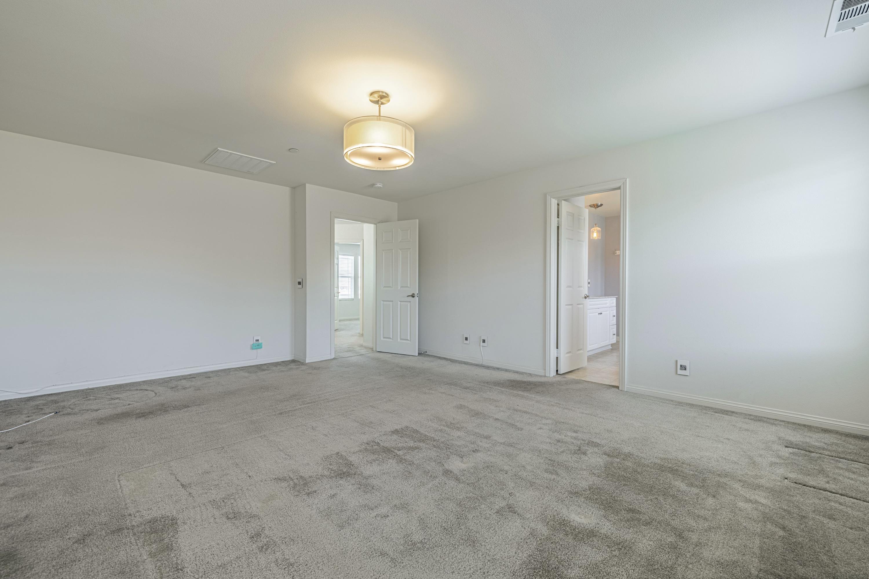 2732 Hemlock Road Palmdale, CA 93551 - Photo 16 of 42 an empty room with windows and wooden floor