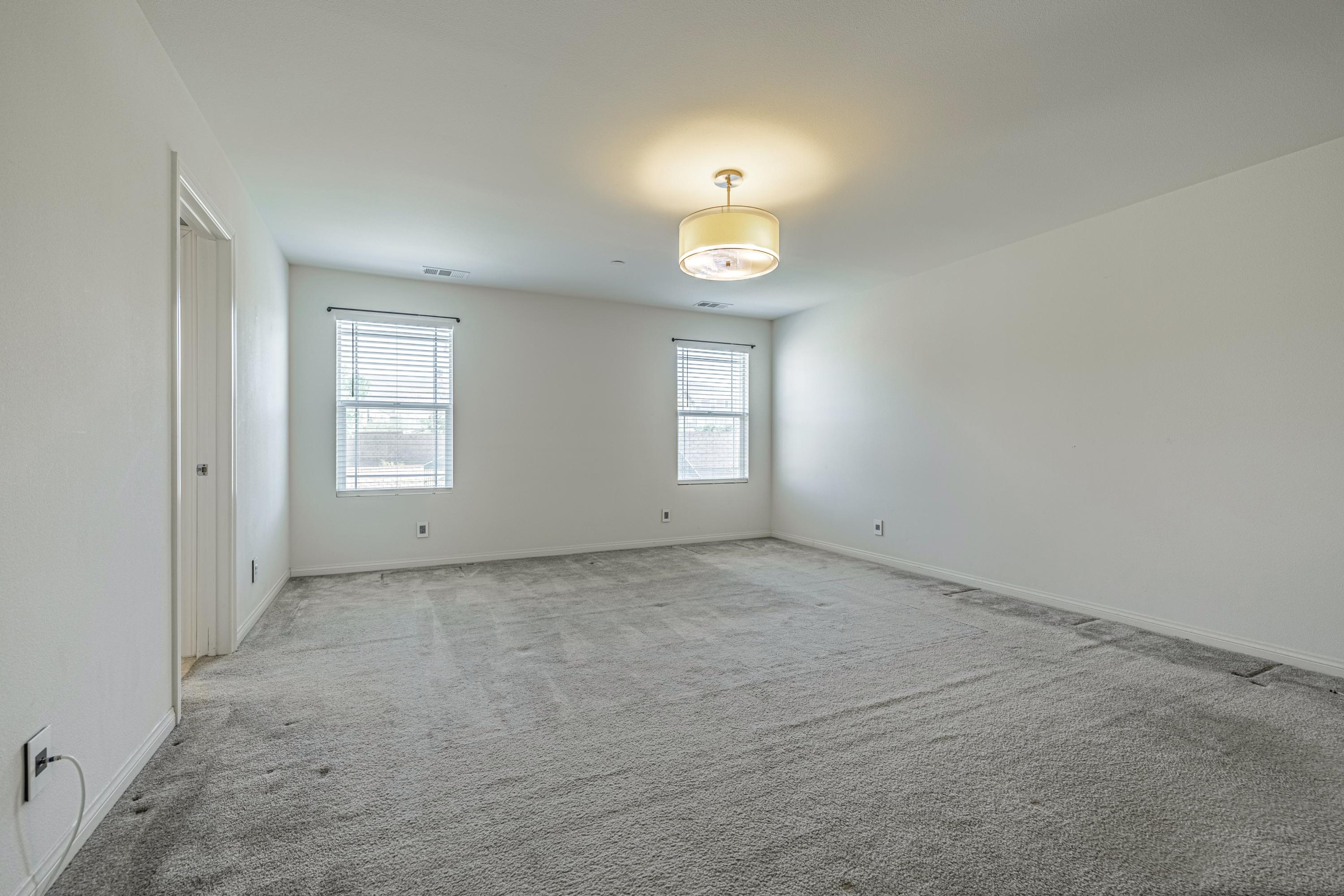 2732 Hemlock Road Palmdale, CA 93551 - Photo 17 of 42 an empty room with windows and entrance