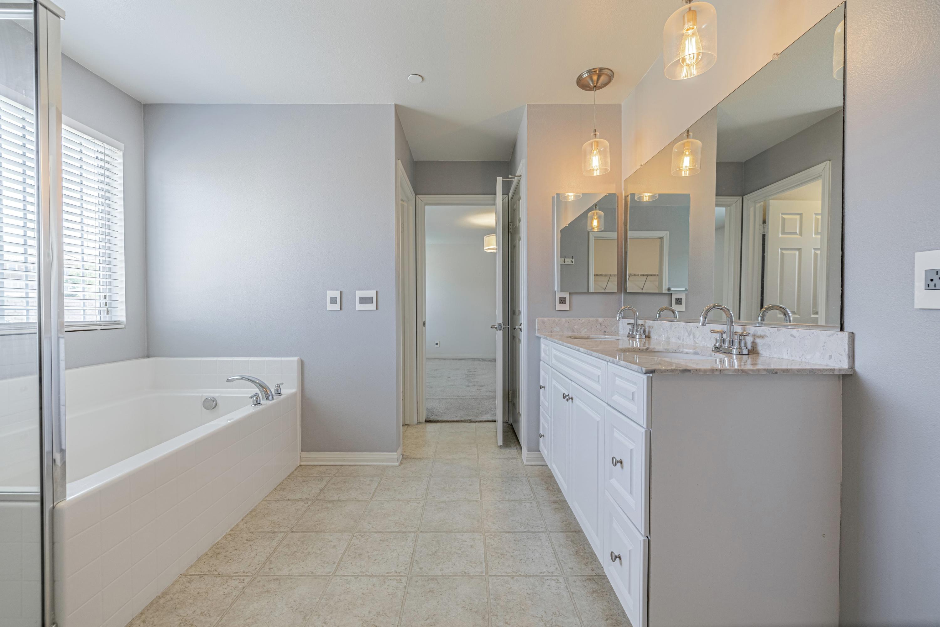 2732 Hemlock Road Palmdale, CA 93551 - Photo 19 of 42 a spacious bathroom with a tub sink shower and mirror