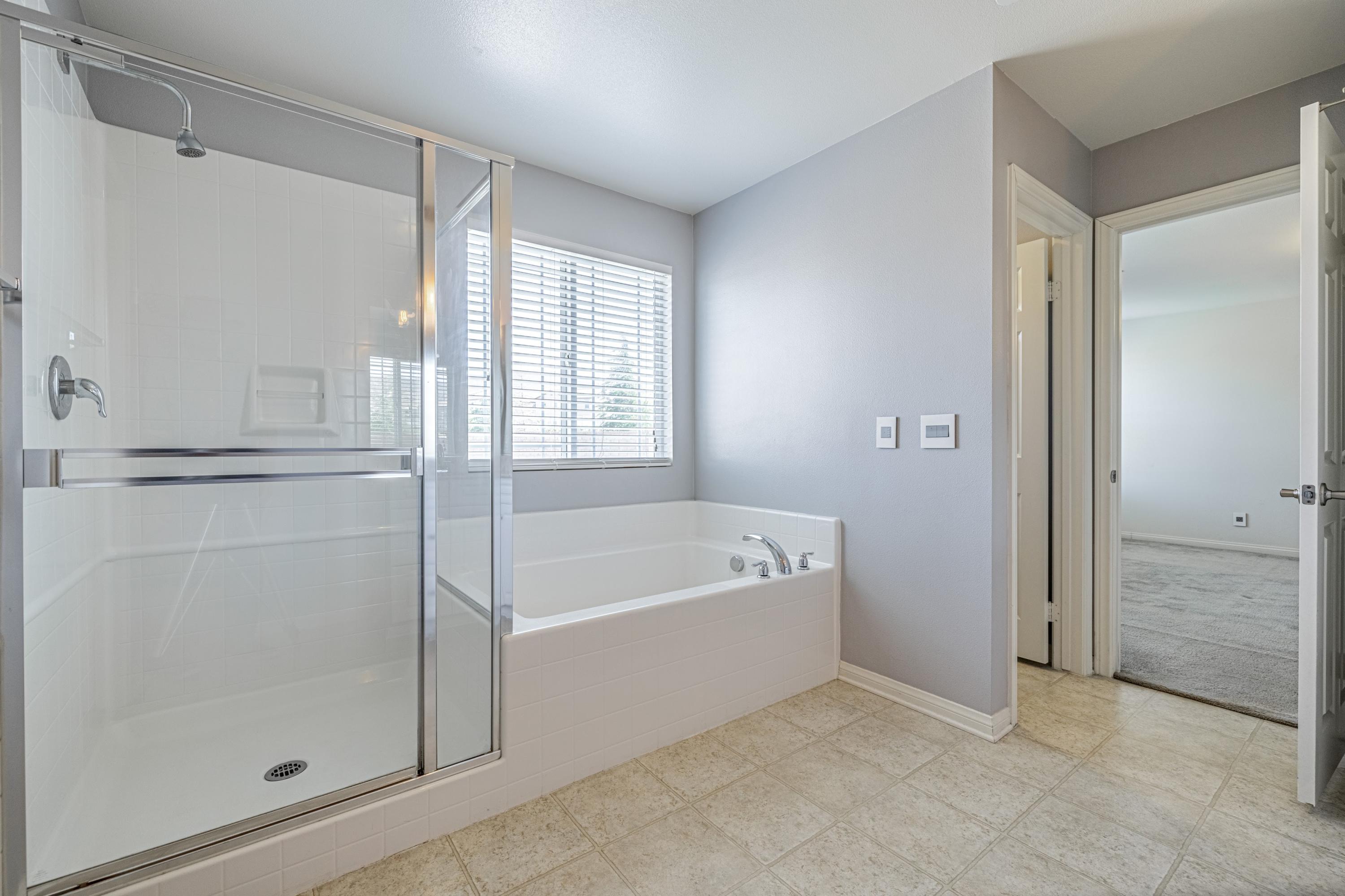 2732 Hemlock Road Palmdale, CA 93551 - Photo 20 of 42 a bathroom with a bathtub and a shower