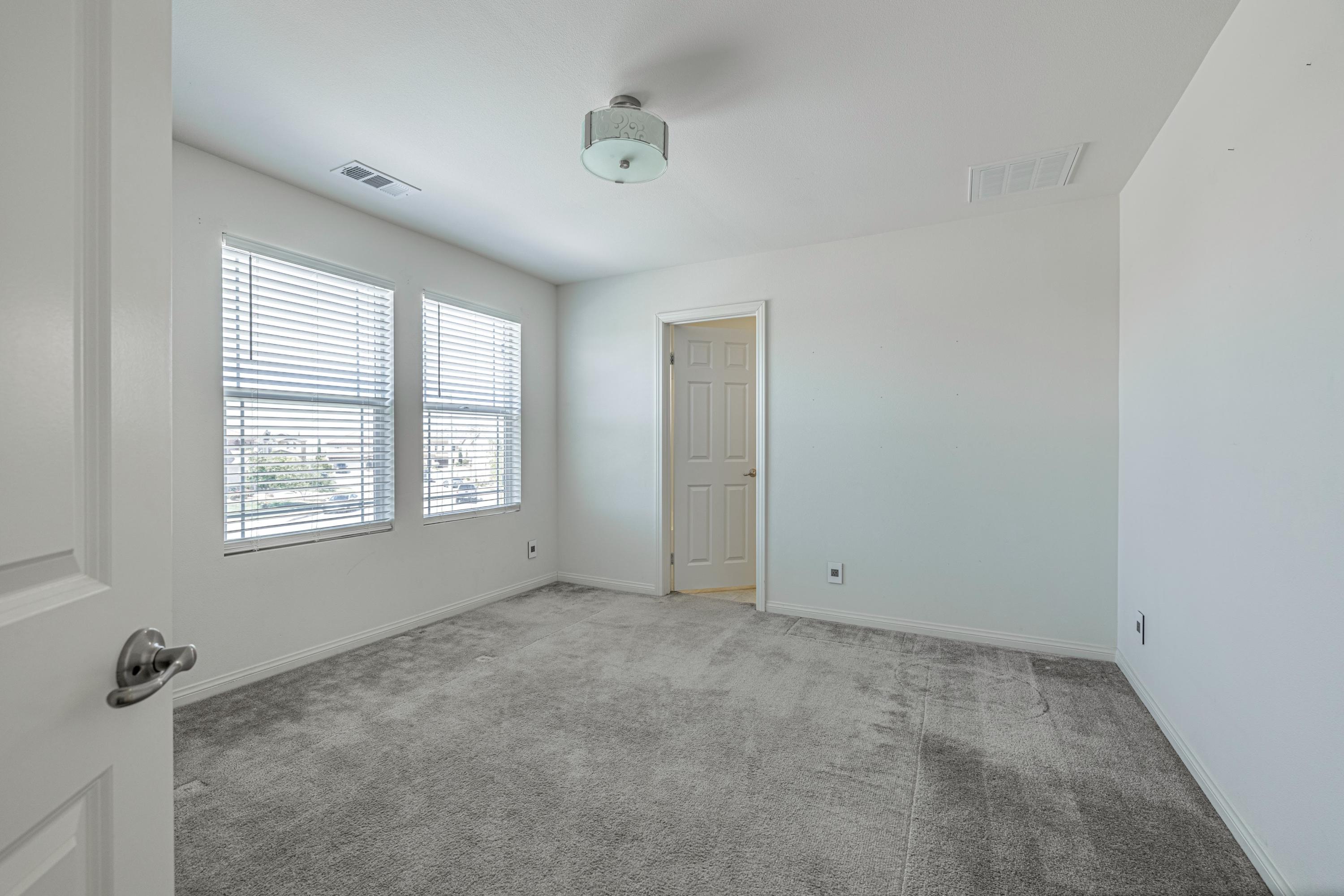 2732 Hemlock Road Palmdale, CA 93551 - Photo 25 of 42 a view of an empty room with a window