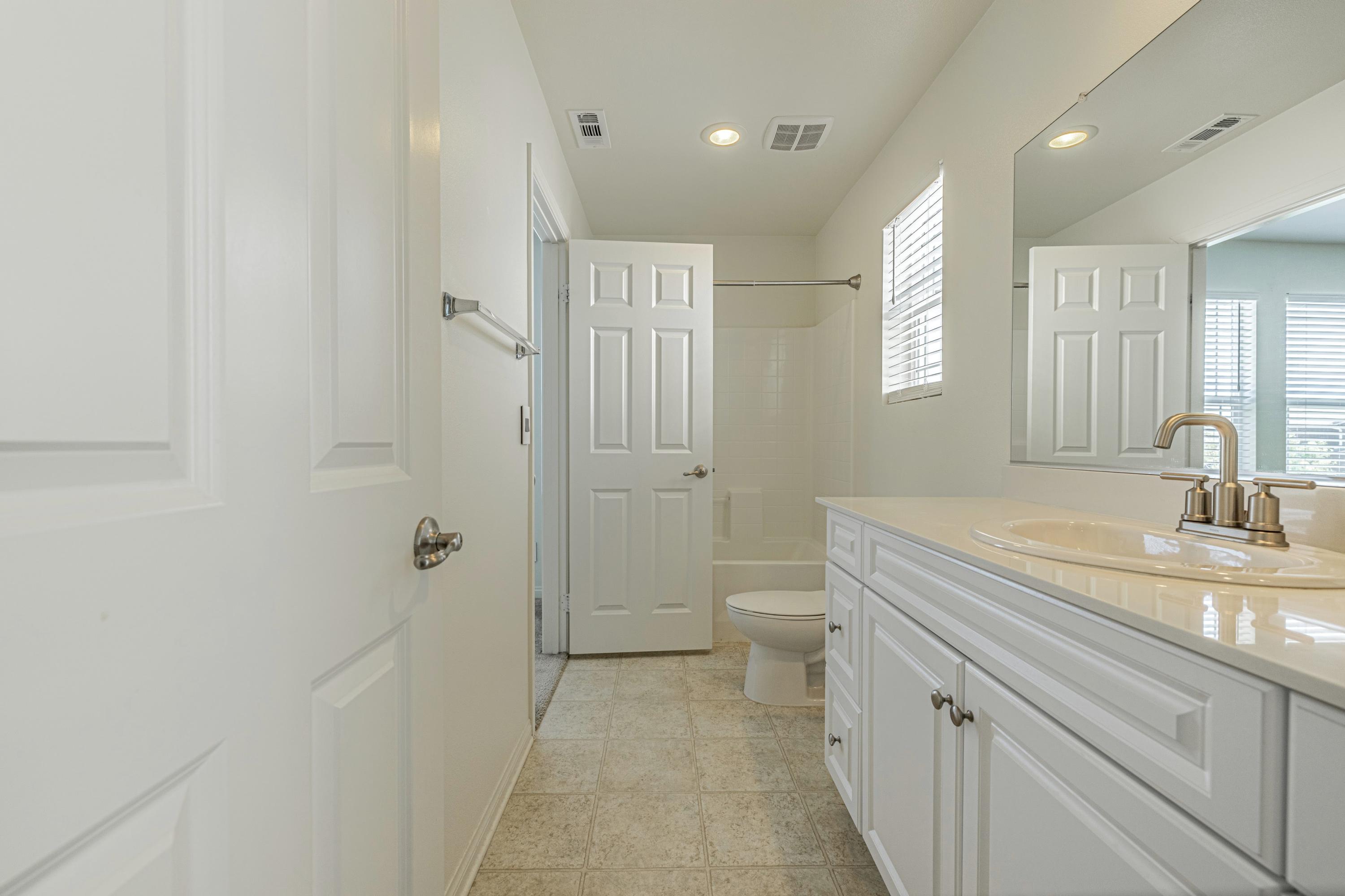 2732 Hemlock Road Palmdale, CA 93551 - Photo 29 of 42 a bathroom with a sink a toilet and shower