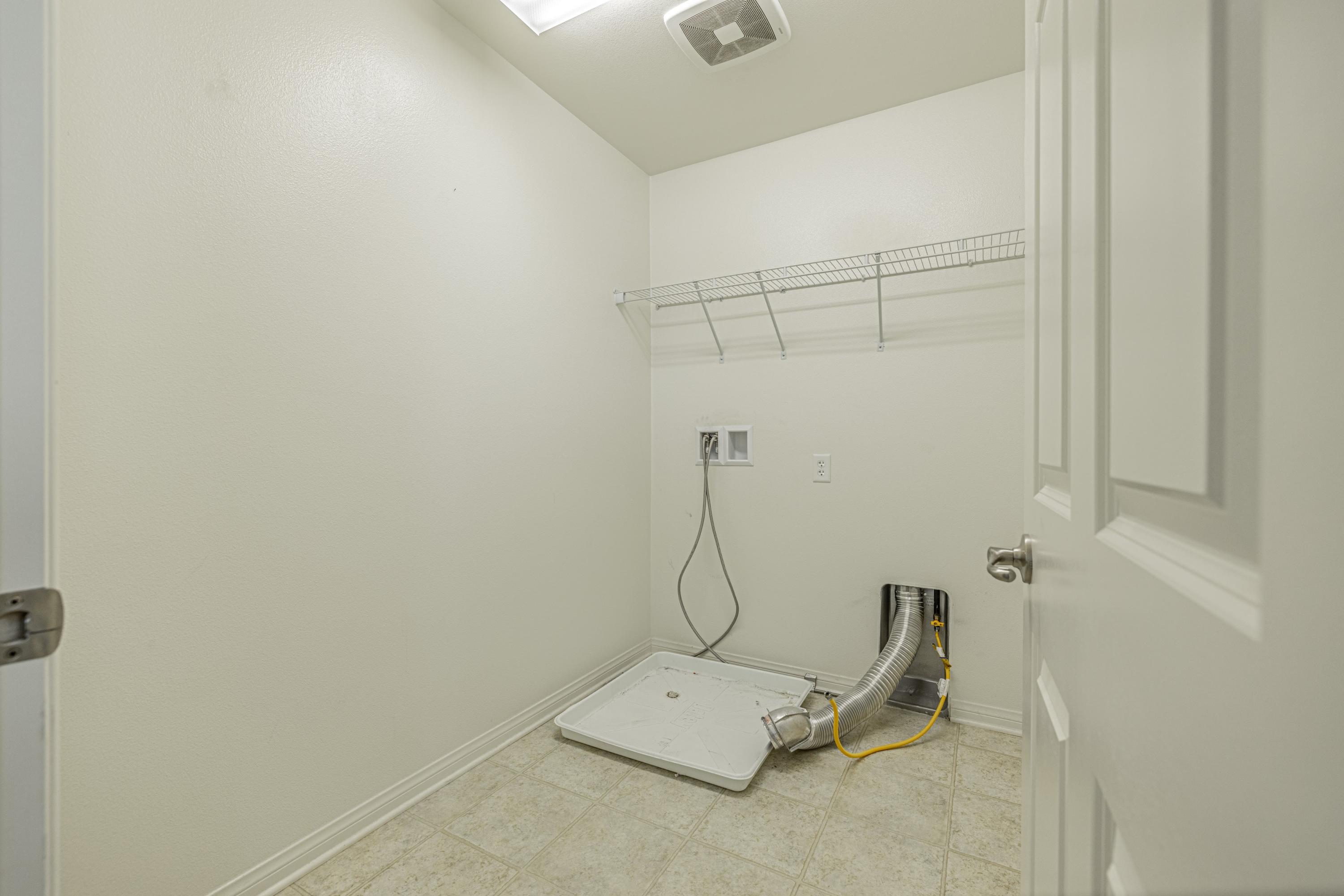 2732 Hemlock Road Palmdale, CA 93551 - Photo 30 of 42 a room with a dryer and white walls