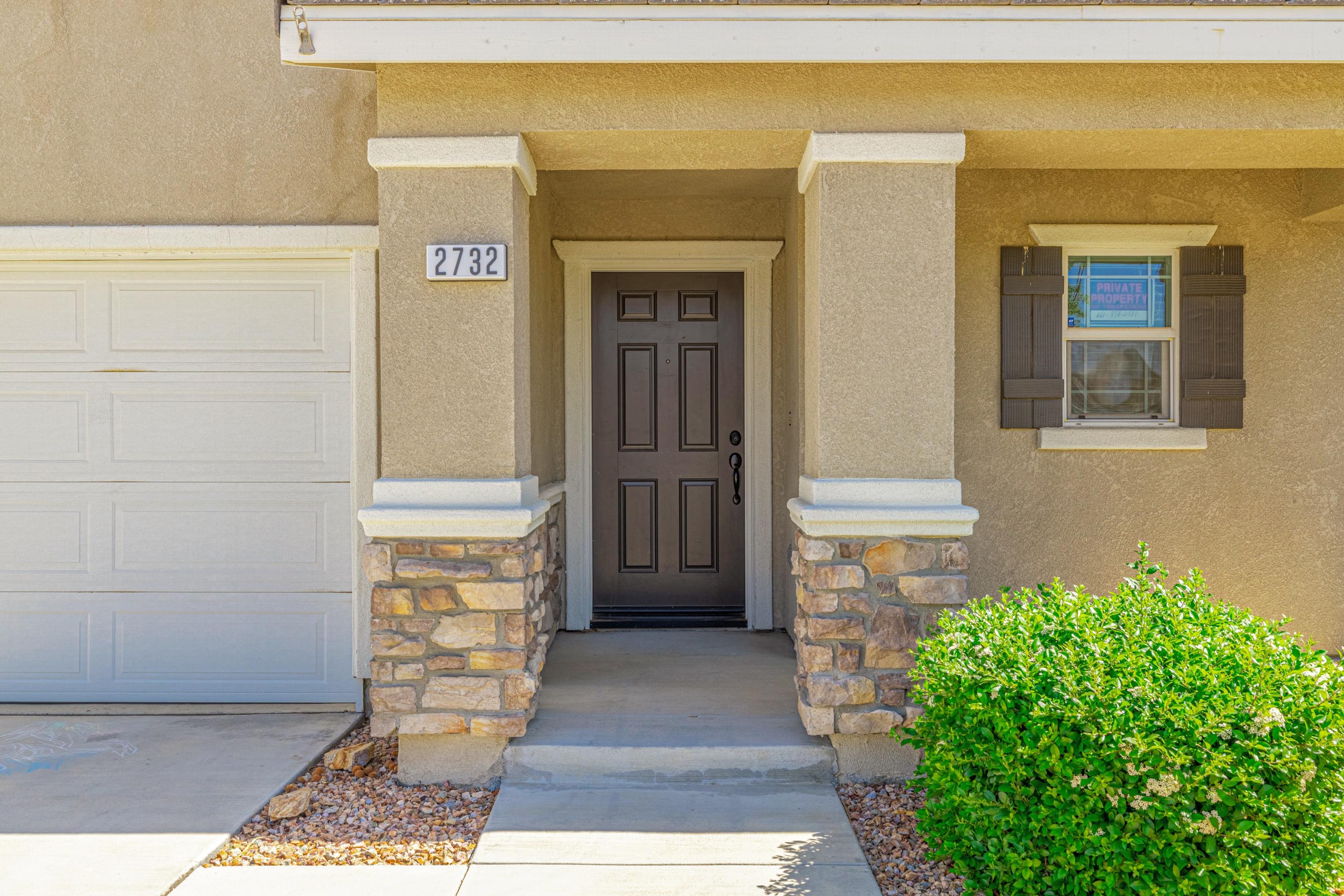 2732 Hemlock Road Palmdale, CA 93551 - Photo 4 of 42 a front view of a house with a garage