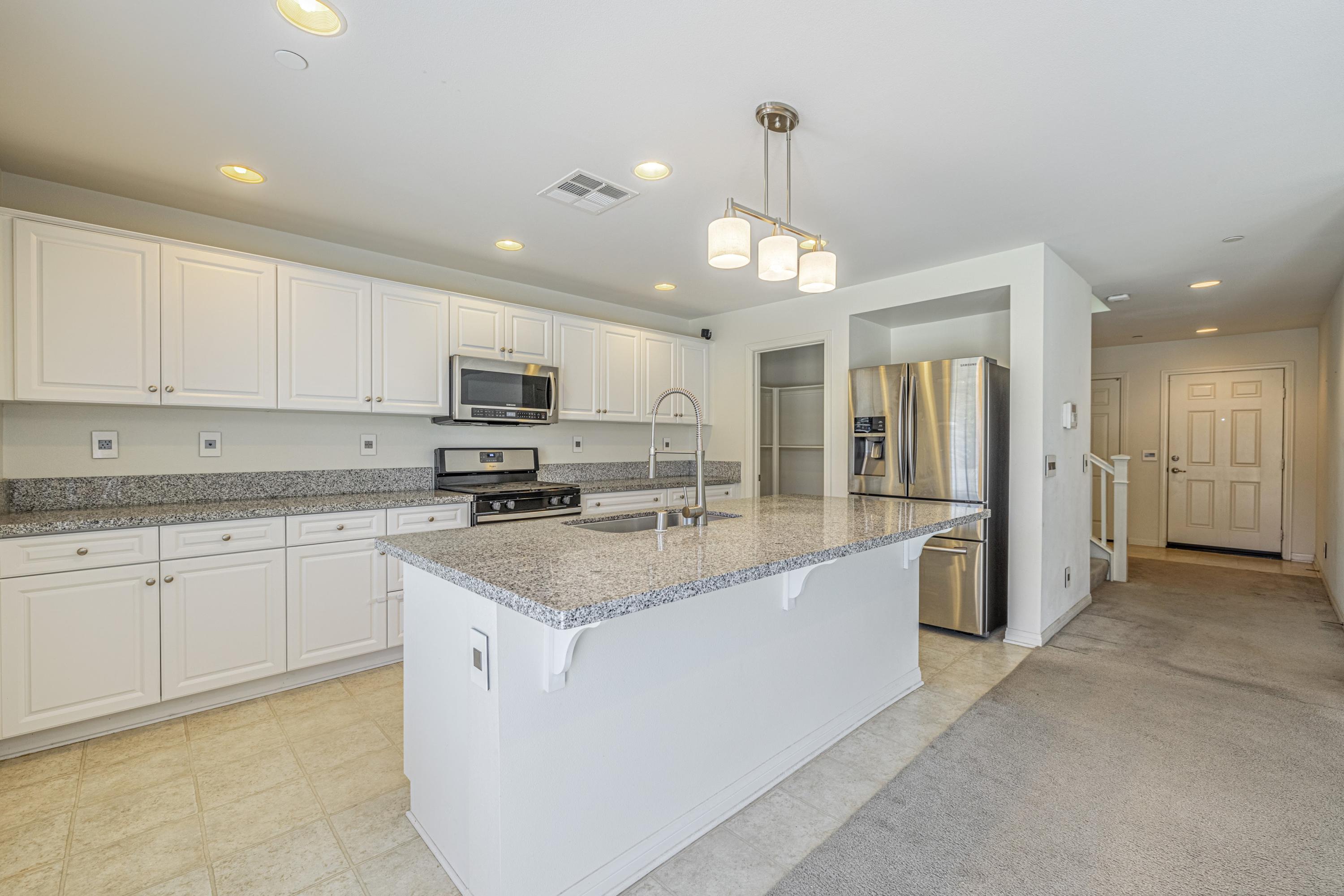 2732 Hemlock Road Palmdale, CA 93551 - Photo 8 of 42 a kitchen with stainless steel appliances granite countertop a sink stove and refrigerator