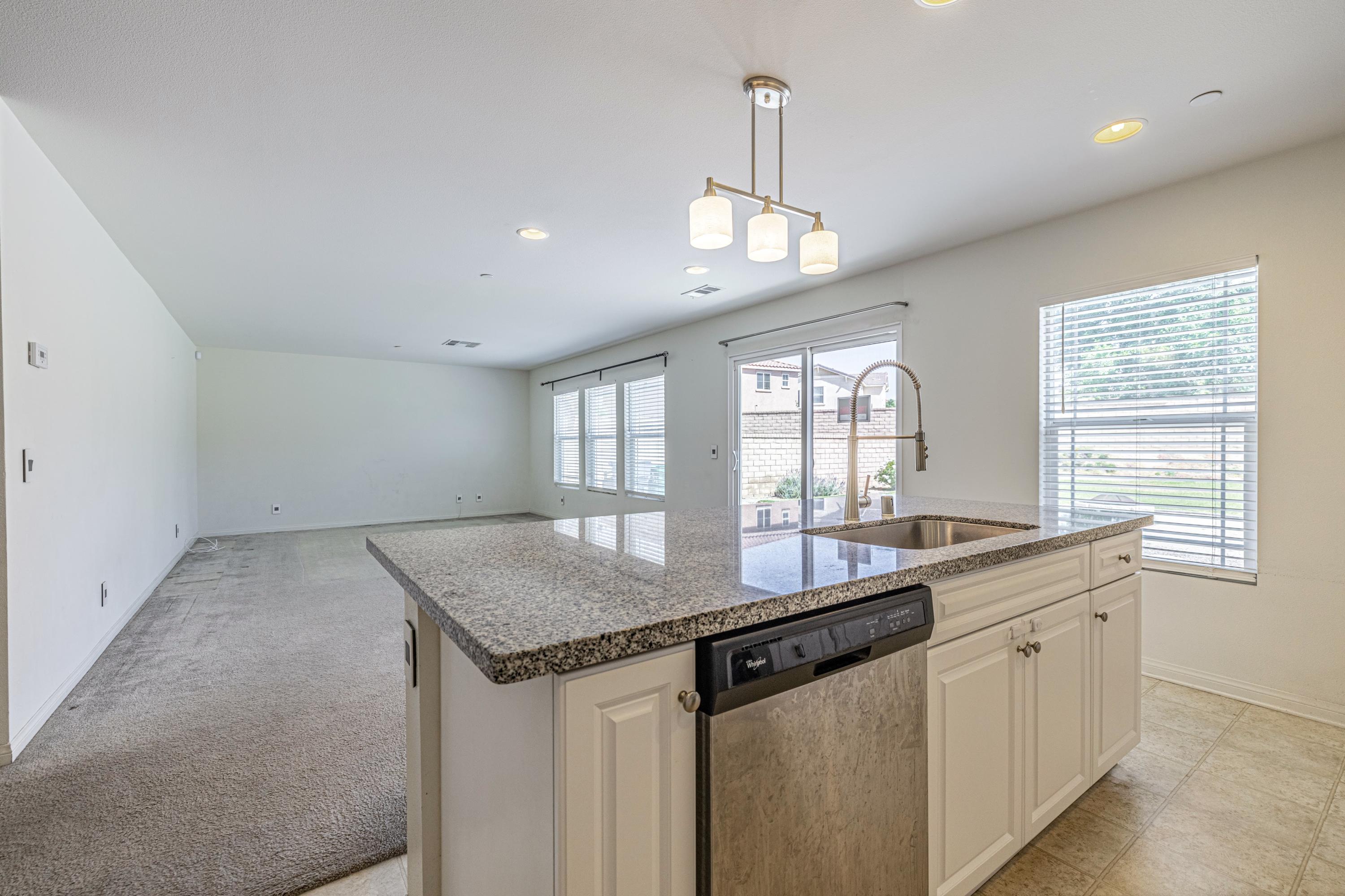 2732 Hemlock Road Palmdale, CA 93551 - Photo 9 of 42 a kitchen with granite countertop a sink and window