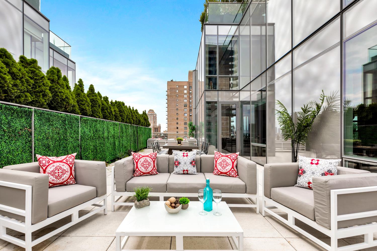 a view of the patio with couches and a potted plant on a table