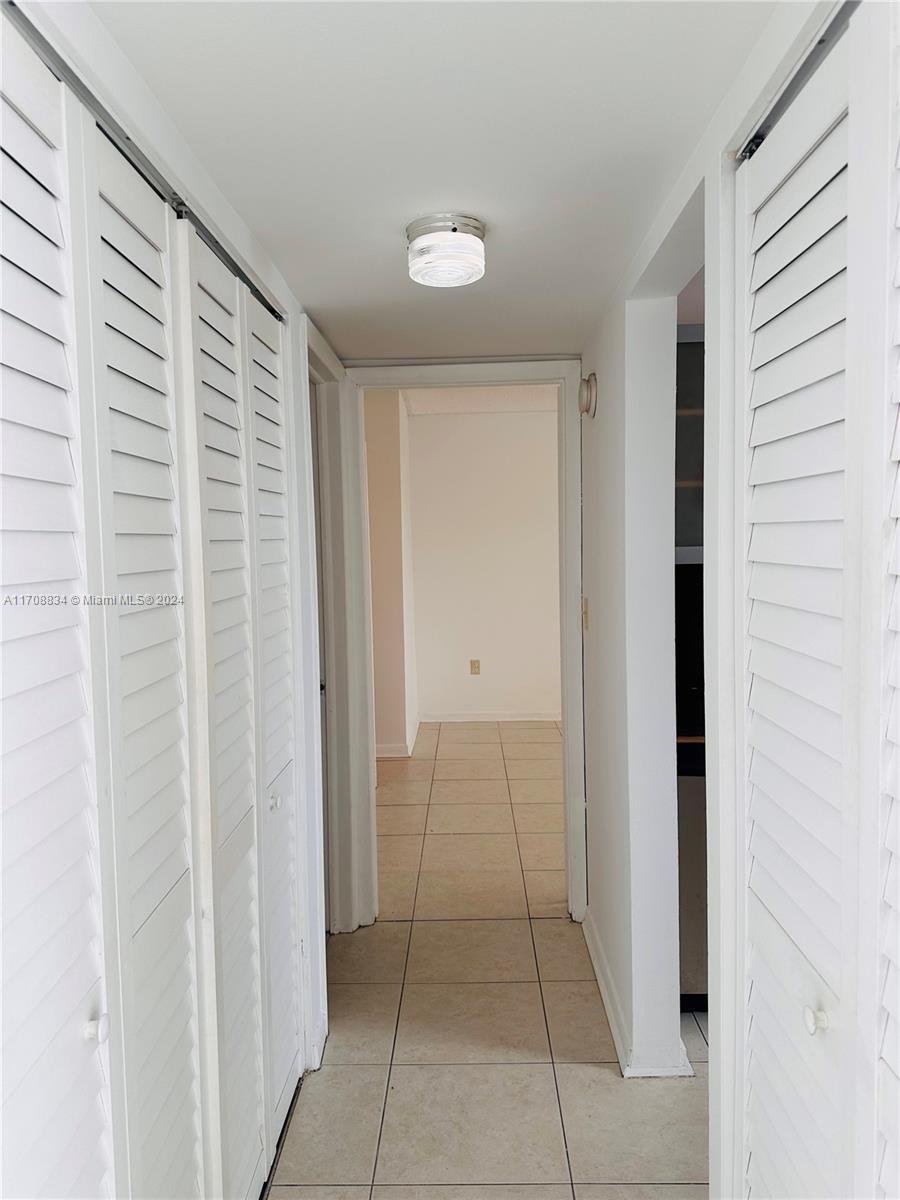 1250 Alton Road, Unit 5F Miami Beach, FL 33139 - Photo 11 of 27 a view of a closet area with en suite bathroom