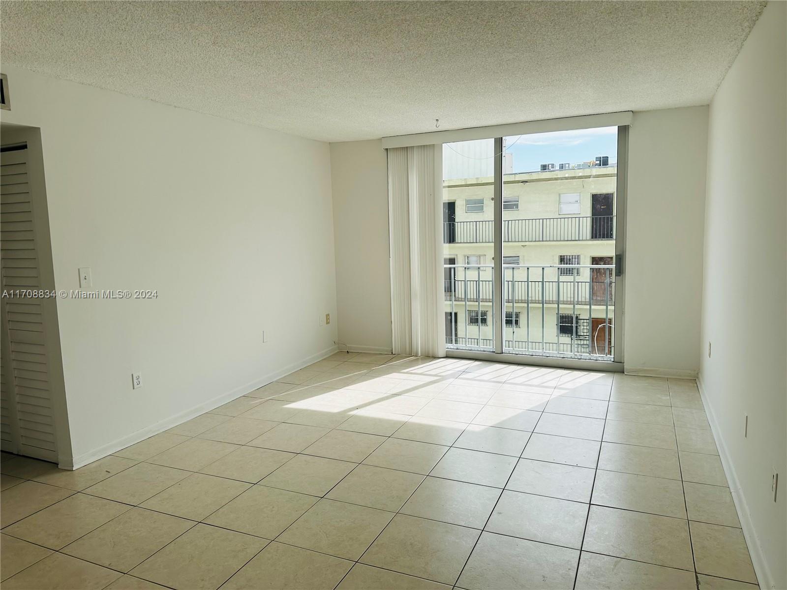 1250 Alton Road, Unit 5F Miami Beach, FL 33139 - Photo 7 of 27 a view of an empty room with a window
