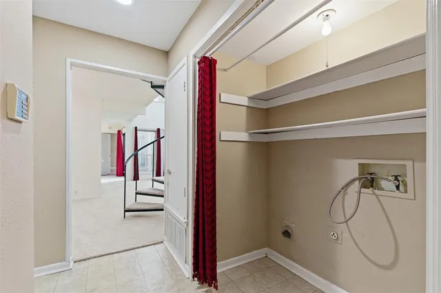 a view of a room with rack on the wall and a window