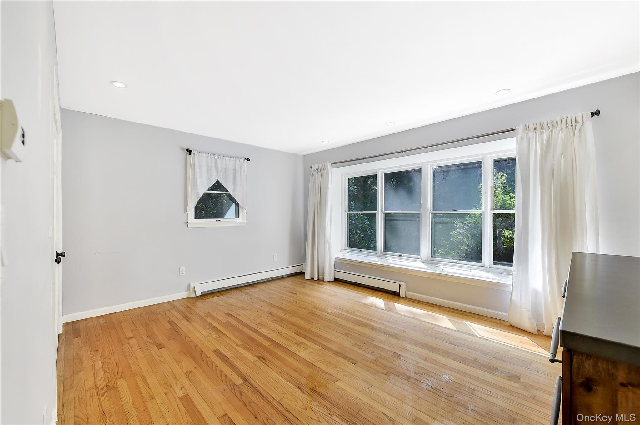 18 Stage Road Pine Island, NY 10969 - Photo 8 of 17 a view of an empty room with a window and wooden floor