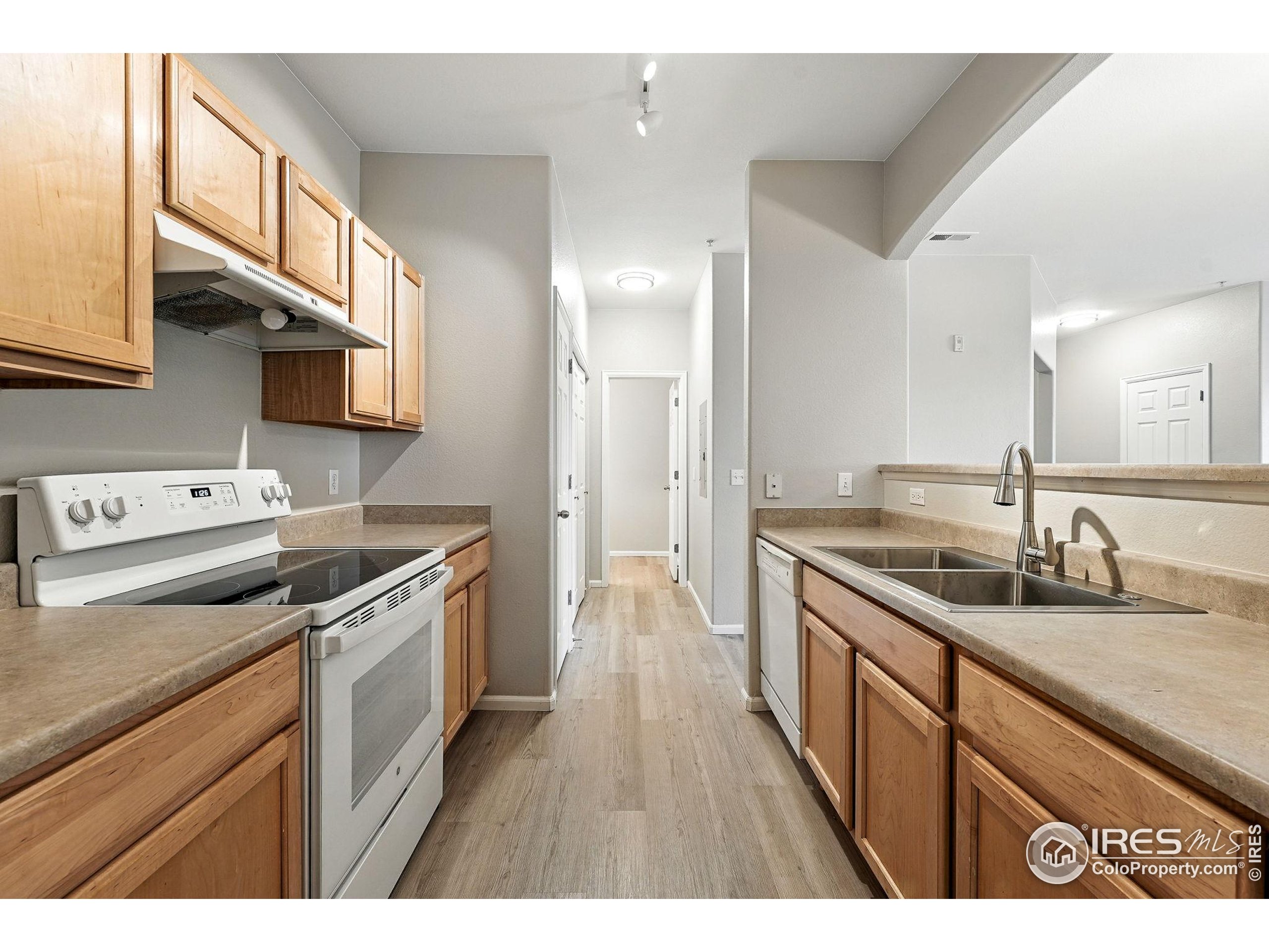5255 Memphis Street, Unit 312 Denver, CO 80239 - Photo 12 of 44 a kitchen with a sink stove top oven and refrigerator