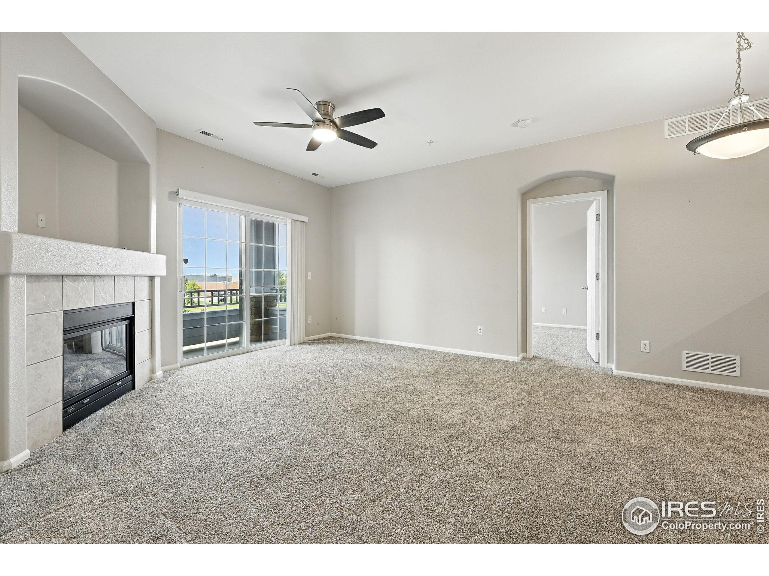 5255 Memphis Street, Unit 312 Denver, CO 80239 - Photo 23 of 44 a view of an empty room with a fireplace