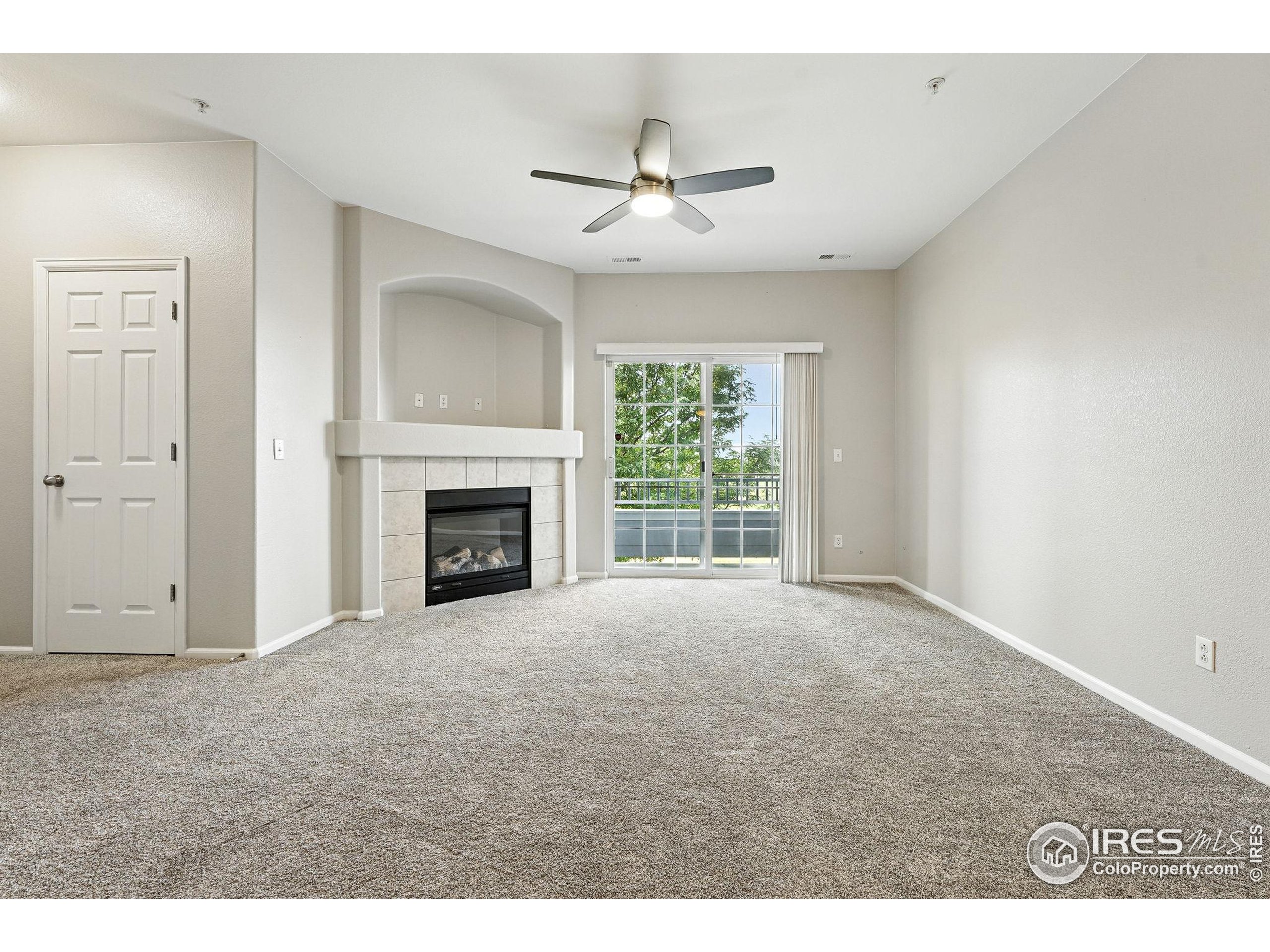 5255 Memphis Street, Unit 312 Denver, CO 80239 - Photo 24 of 44 a view of an empty room with a fireplace