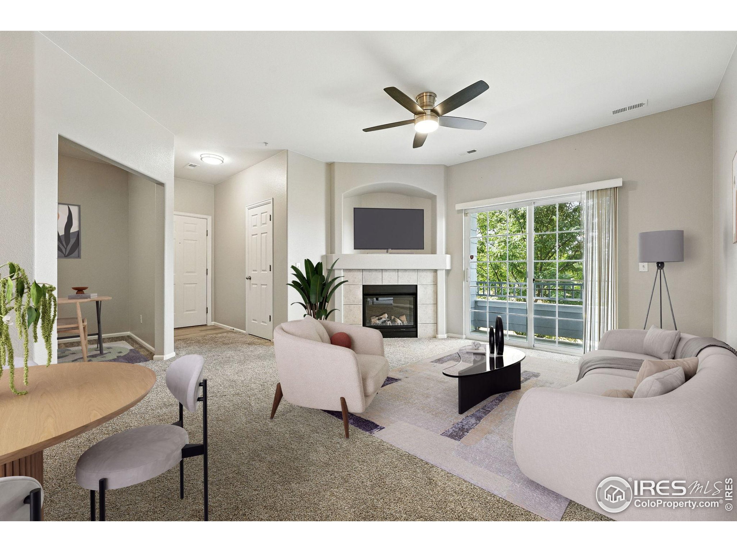 5255 Memphis Street, Unit 312 Denver, CO 80239 - Photo 3 of 44 a living room with furniture a fireplace and a large window