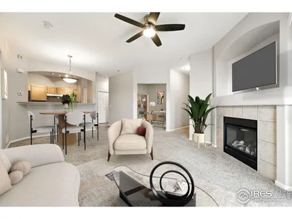 a living room with furniture a flat screen tv and a fireplace