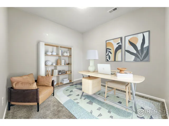 a living room with furniture a rug and a window