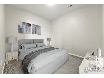 a bedroom with a bed and a night stand