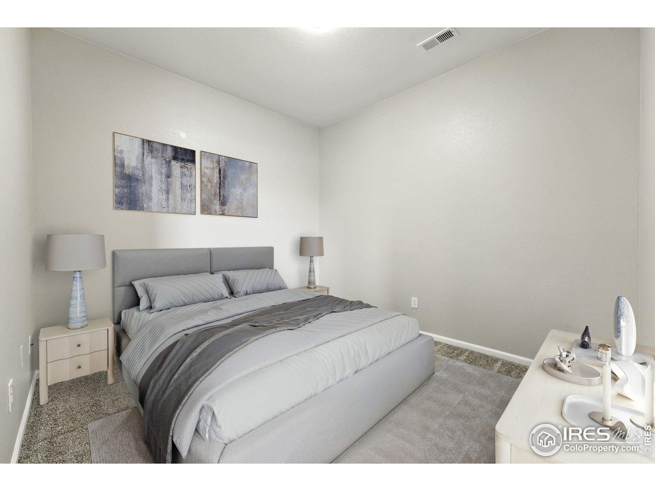 5255 Memphis Street, Unit 312 Denver, CO 80239 - Photo 8 of 44 a bedroom with a bed and a night stand