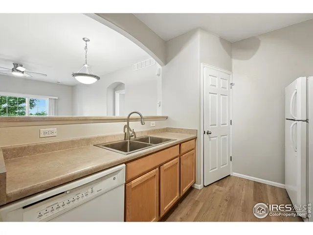 a kitchen with a sink stove top oven and refrigerator