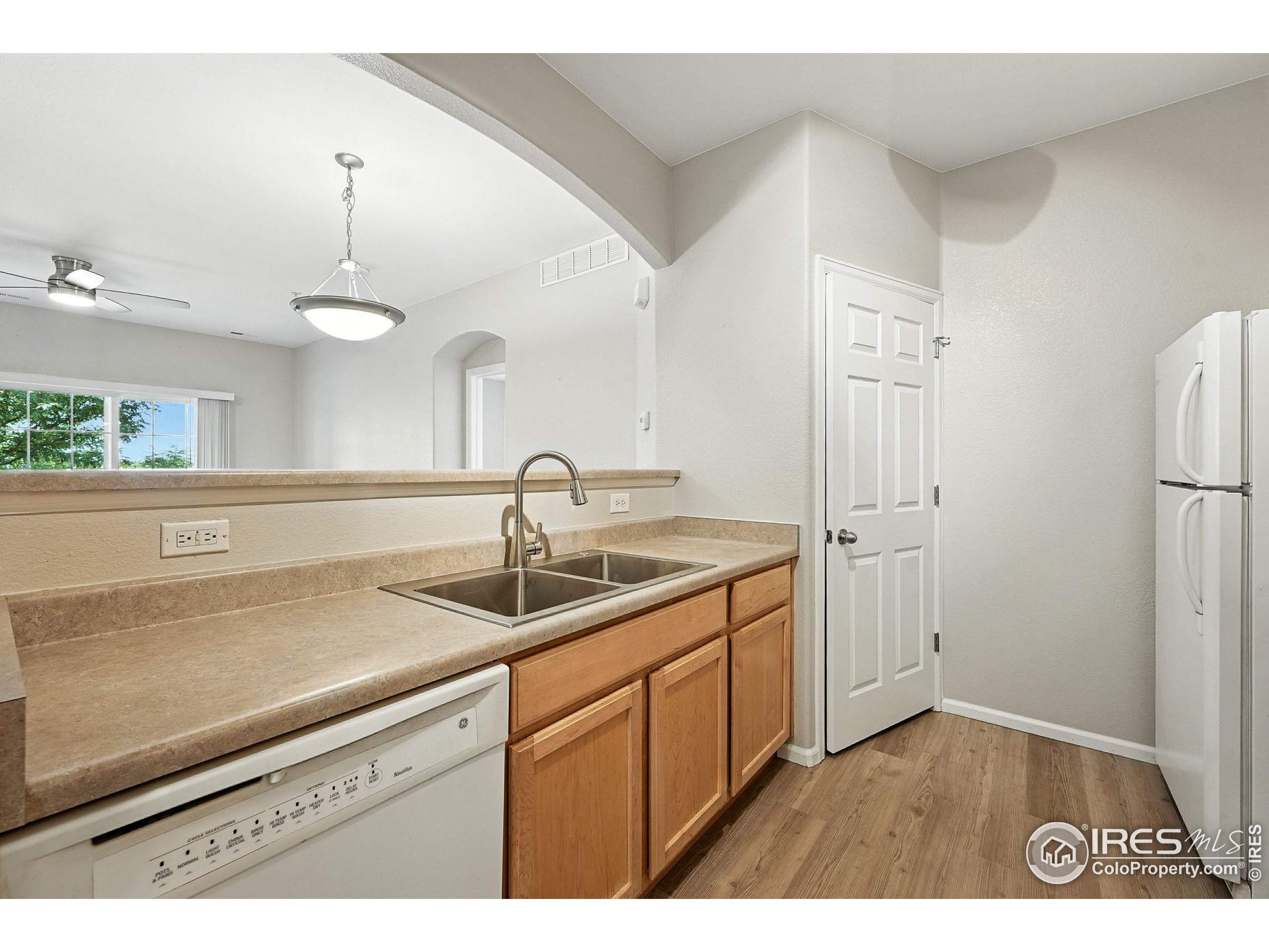 5255 Memphis Street, Unit 312 Denver, CO 80239 - Photo 10 of 44 a kitchen with a sink and a refrigerator
