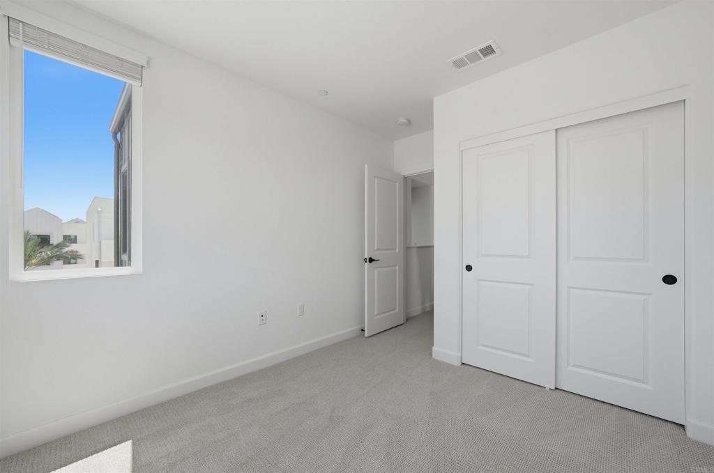 2402 Cascalote Loop San Diego, CA 92154 - Photo 23 of 35 a view of an empty room with window and closet area