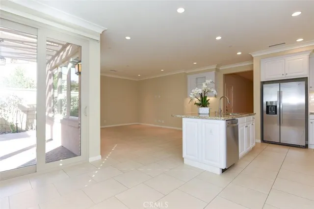 a kitchen with granite countertop a refrigerator and a stove top oven